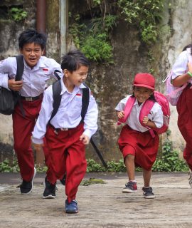 Excited Indonesian primary school kids running cheerful