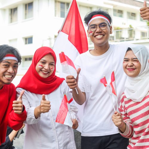 Excited young people raised arm on Indonesian independence day celebration
