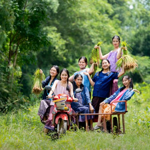Group of Asian young teenage girls sit on motorcycle sidecar with smiling and someone