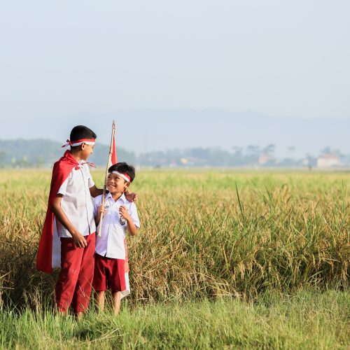 Indonesian elementary student wearing flag atribute